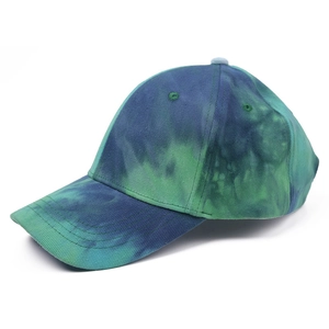 Detailed side view of tie-dye baseball cap featuring blue and green cotton canvas texture