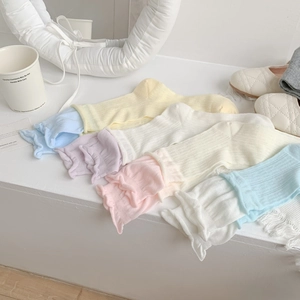 Pastel colored crew socks with ruffle cuffs and vertical ribbed knit texture