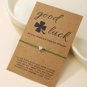 Green braided heart bracelet on a Good Luck card, featured in a gift presentation