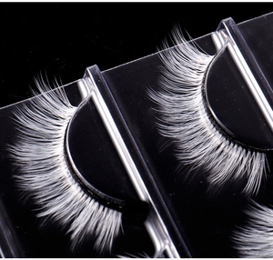 Detailed macro view of white synthetic fiber eyelashes for festive cosplay and stage makeup