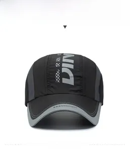 Detailed front view of black quick-dry sport cap with grey mesh and DIN embroidery