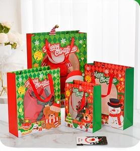 Detailed view of Christmas gift bags with transparent windows and festive holiday patterns
