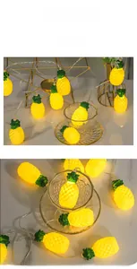 Vista macro di luci a LED a forma di ananas giallo caldo su superficie di marmo