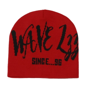 Detail of red knit beanie with black WAVE graffiti jacquard and SINCE 1996 text design