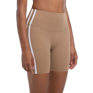 Detail view of khaki yoga shorts with white side stripes and high-waisted elastic fabric