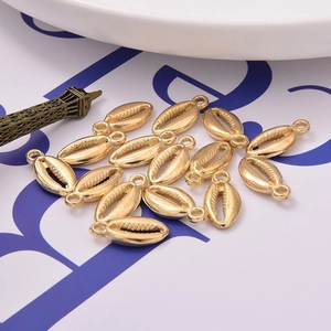 Golden shell-shaped CCB plastic pendants for DIY jewelry making on white display