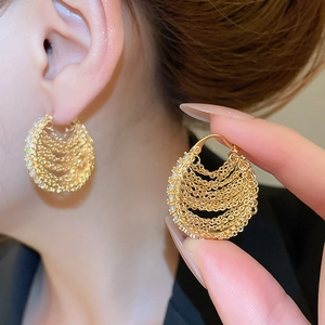 Detail shot of 18k gold plated multi-layer chain hoop earrings with sparkling cubic zirconia