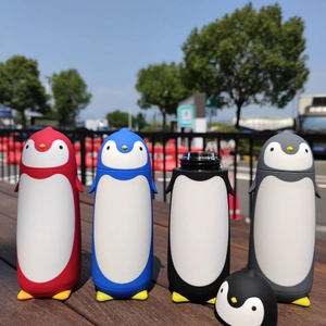 Outdoor display of four cartoon penguin-shaped stainless steel vacuum water bottles