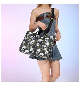 Detail of gothic skull print tote bag with floral patterns and wide black strap