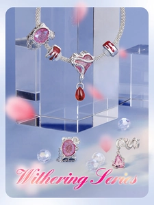 Macro shot of silver S925 snake chain bracelet with pink enamel heart and butterfly charms