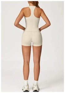 Close-up of racerback sports vest and tight shorts set in cream beige yoga wear