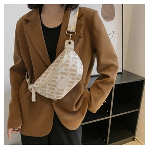 Close-up of beige crossbody bag with letter print and adjustable jacquard strap