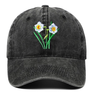 Detailed embroidery of a narcissus flower on a washed grey vintage denim baseball cap
