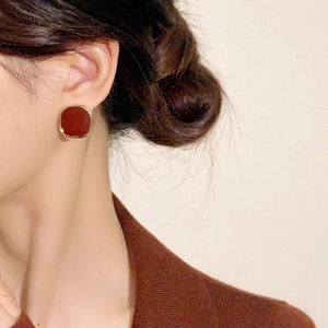 French retro square gold-edged burgundy earrings shown worn on a model's ear