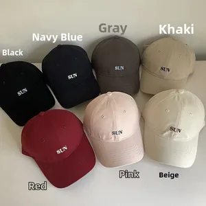 Detailed view of sun embroidered cotton baseball caps in seven assorted vibrant colors