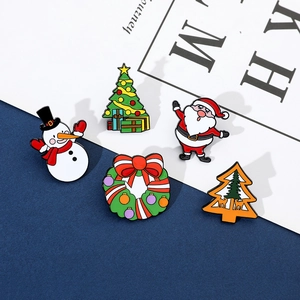 Set of five festive enamel Christmas pins featuring Santa, Snowman, and Tree details
