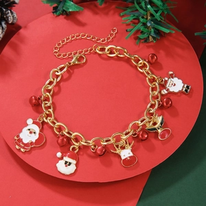 Detailed view of Christmas charm bracelet with Santa and Reindeer pendants on red stand