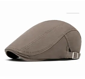 Detail view of military green newsboy cap fabric texture and silver metal buckle