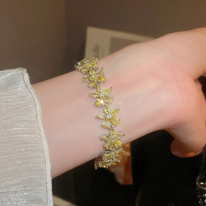 Detailed view of yellow zircon flower bracelet featuring pear-cut stones and silver plating