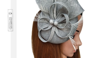 Detailed view of gray sinamay floral fascinator with elegant long feathers and beads