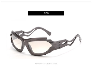 Detail of futuristic gunmetal sunglasses with hollow wavy temples and tea tinted lenses