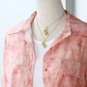 Detail of cute gold teddy bear pendants with pink and blue crystal zircon inlay
