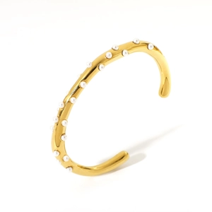 Minimalist 18K gold-plated cuff bracelet with white pearl accents on white background