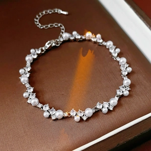 Detailed view of the irregular zircon and pearl bracelet on a jewelry display box