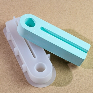 Detail of two-piece oval silicone candle holder molds in translucent and blue colors