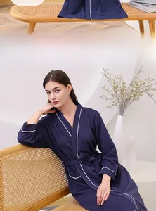 Detail of navy blue waffle weave bathrobe showing V-neck design and white contrast piping