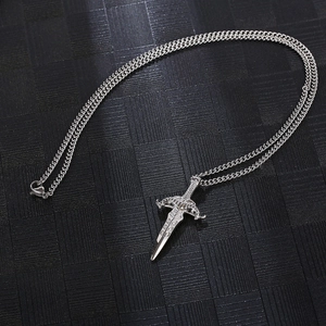 Macro shot of silver stainless steel sword pendant with intricate engraving on O-chain