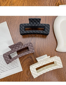 Three-piece hair claw clip set featuring classic quilted textures in black brown and cream