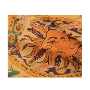 Macro view of sun face motif and celestial patterns on woven bohemian tapestry