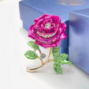 Elegant rose flower brooch with pink enamel petals and sparkling rhinestones on gold alloy