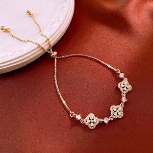 Elegant gold plated clover bracelet with sparkling zircons and adjustable sliding closure