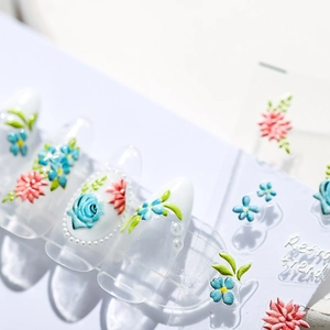 3D floral nail art stickers featuring blue roses and pink daisies with relief texture