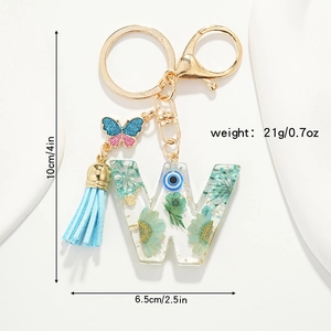 Detailed view of Letter W resin keychain with blue dried flowers and size dimensions