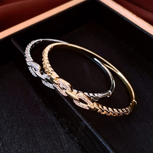 Detailed macro of gold and silver chain bracelets with sparkling rhinestones in a velvet box