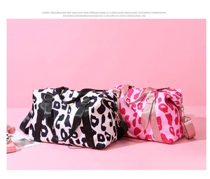 Cow print oxford travel bags in black and pink with reinforced handles and metal hooks