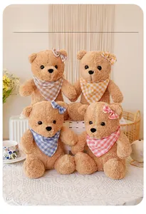 Macro detail of four plush teddy bears with plaid scarves and matching hair bows