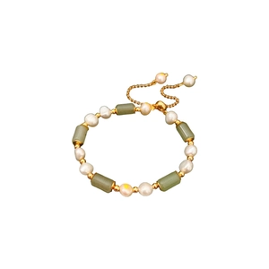 Bamboo style gold plated bracelet with pearls and green jade stones on white background