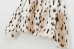 Detail shot of soft faux fur fabric with natural lynx spots and high-quality texture