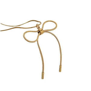 Elegant gold stainless steel snake chain necklace with a vintage bow pendant on white background