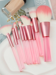 Detailed close-up of 9-piece makeup brush set with pink gradient bristles and clear handles