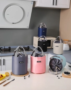 Detail of multi-color cylindrical lunch bags with drawstring closure and top handles