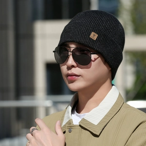 Men's dark gray ribbed knit beanie with leather logo patch for winter outdoor warmth
