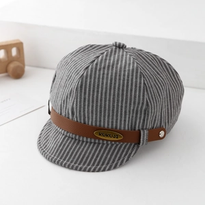 Detail of grey striped infant baker boy hat with brown PU leather band and metal tag