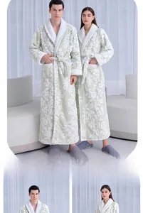 Close-up of thick light green jacquard fleece robe with white floral patterns and tie waist
