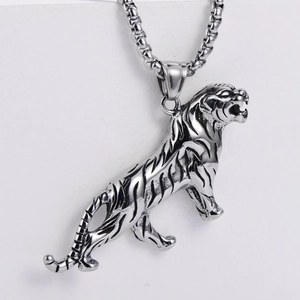 Close-up of a silver roaring tiger head pendant with a square pearl chain necklace
