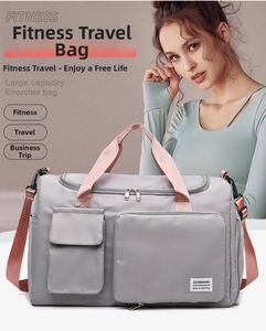 Large gray fitness bag with pink straps showing multi-pocket detail and durable nylon texture